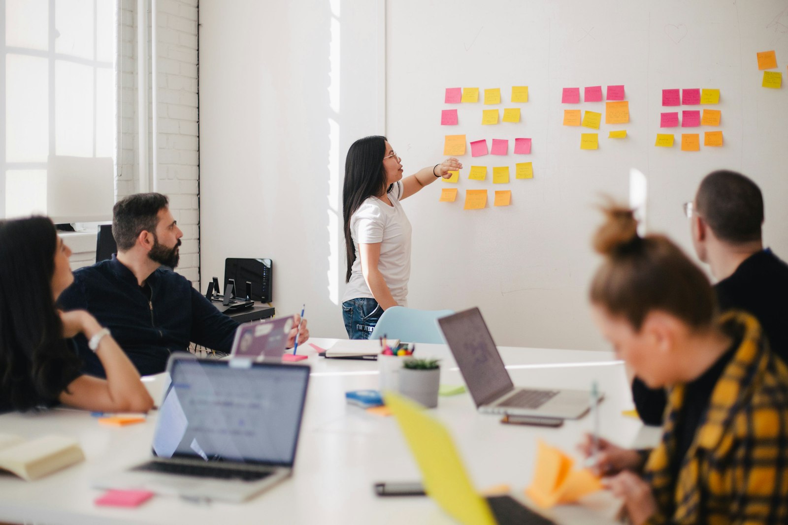 Equipo de producto colaborando frente a un tablero de trabajo